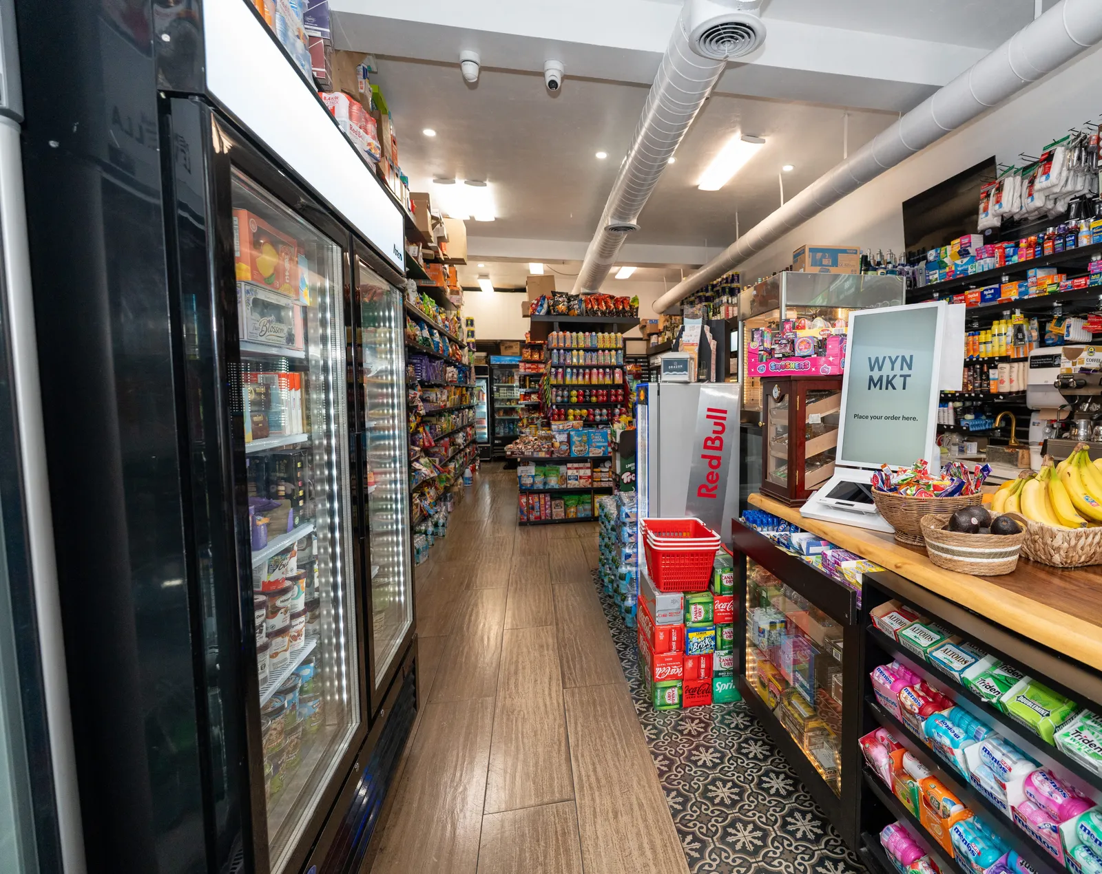 Inside WYN MKT in Wynwood, Miami: the checkout counter, drink coolers and stocked aisles
